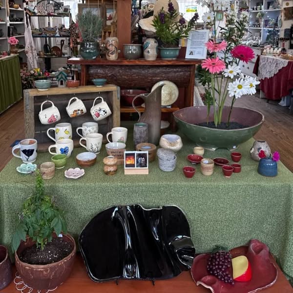 Handmade pottery, mugs, planters and flowers arranged inside Tunnel Mountain Crafts
