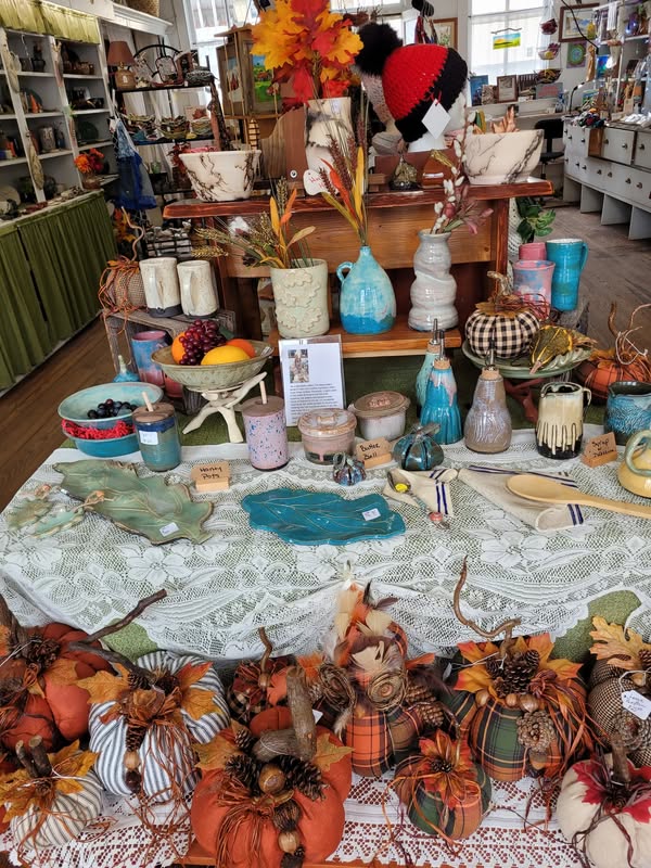 Seasonal pottery showcase and handmade textile pumpkins inside Tunnel Mountain Crafts